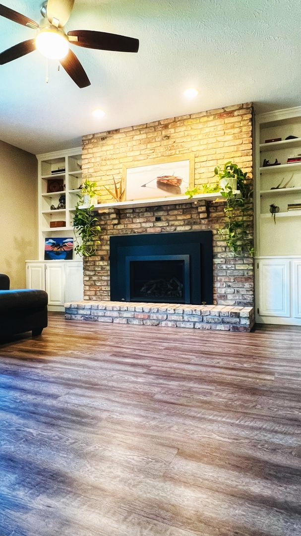 4 Downing Circle Bloomington, IL 61704 - Photo 21 of 69 a view of a living room with a large kitchen counter space and wooden floor