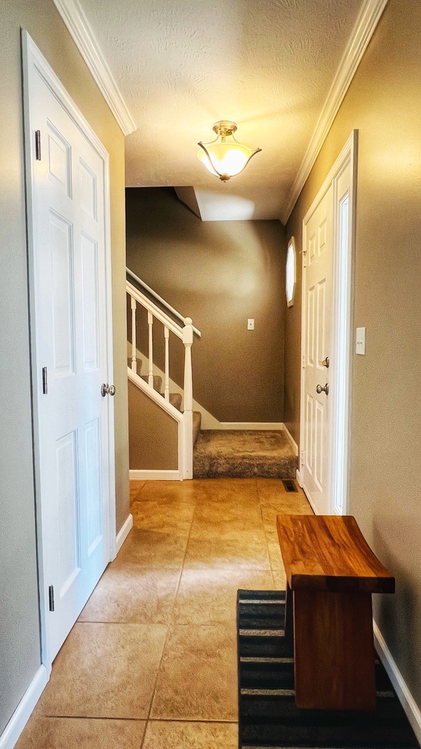4 Downing Circle Bloomington, IL 61704 - Photo 32 of 69 a bedroom with a bed and a chandelier