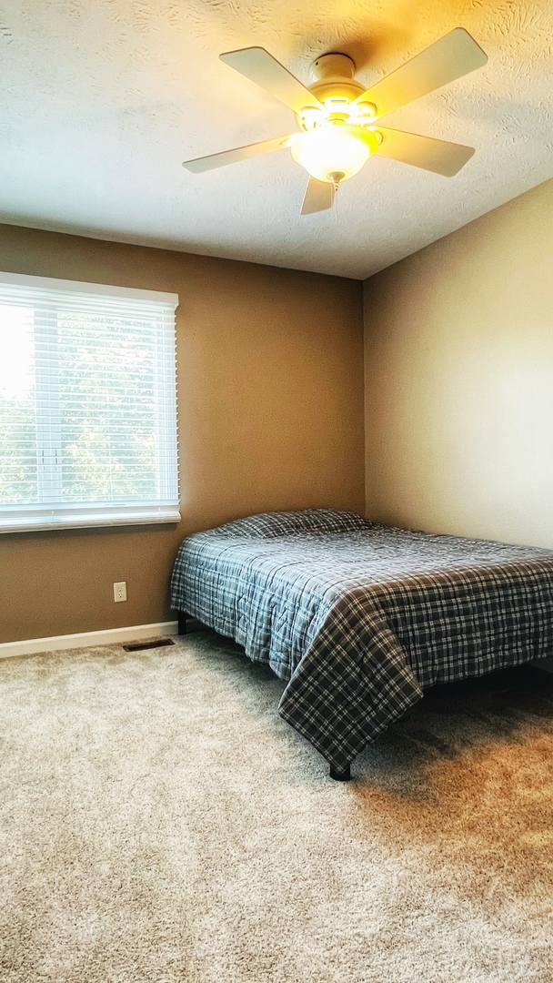 4 Downing Circle Bloomington, IL 61704 - Photo 49 of 69 a bedroom with a bed and window