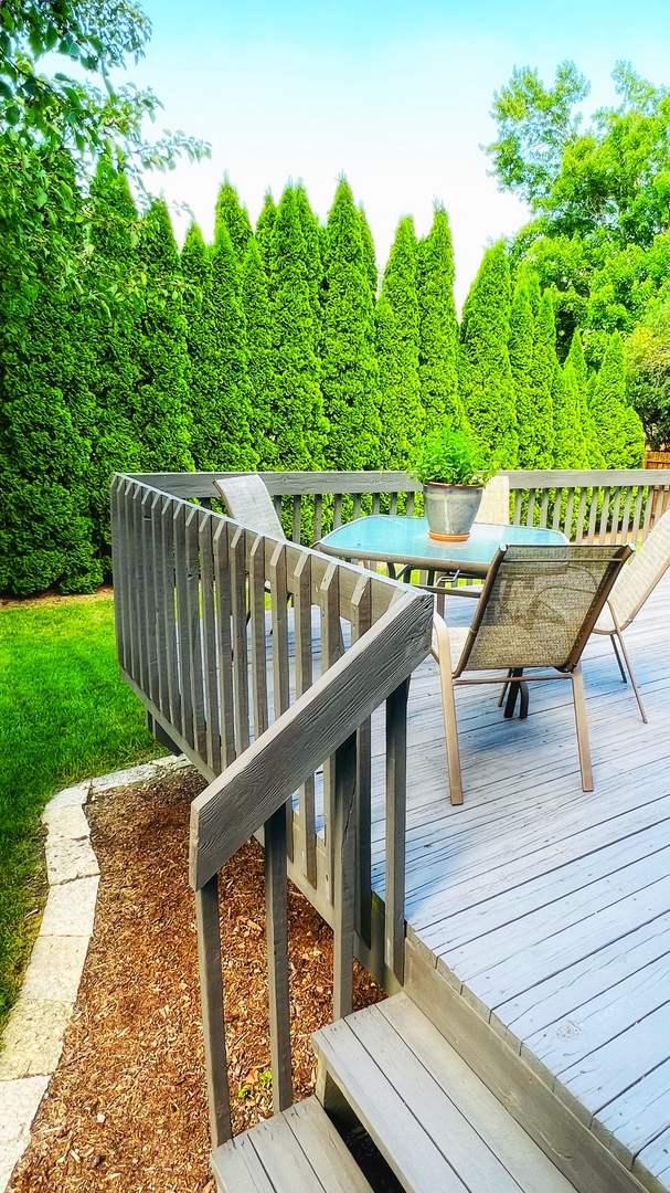 4 Downing Circle Bloomington, IL 61704 - Photo 62 of 69 a balcony with wooden floor and outdoor seating