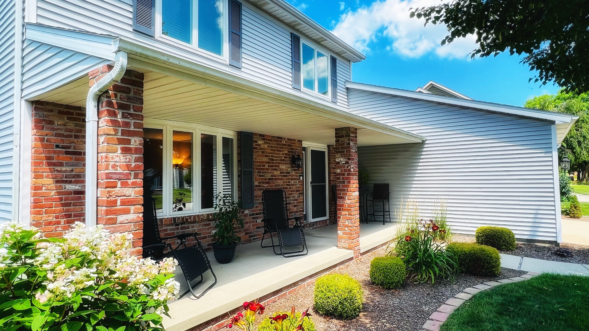 4 Downing Circle Bloomington, IL 61704 - Photo 68 of 69 a view of a house with potted plants and a table and chairs