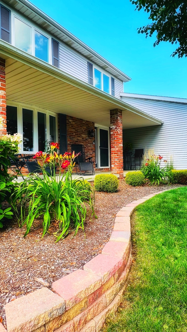 4 Downing Circle Bloomington, IL 61704 - Photo 69 of 69 a front view of a house with porch and garden