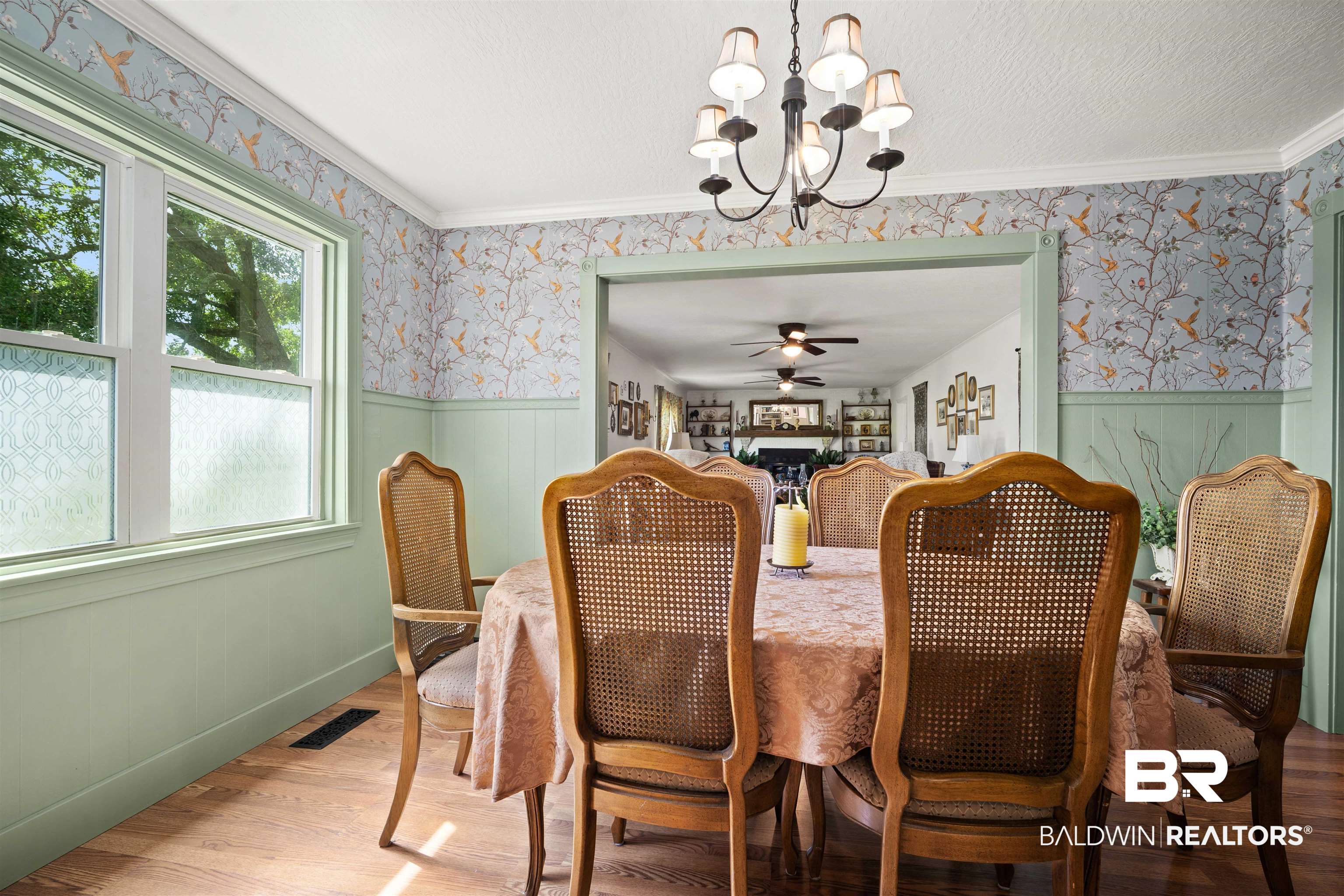 22 Horace Odom Road Millry, AL 36558 - Photo 18 of 39 Dining space with light wood-style flooring, wainscoting, hanging lights, wallpapered walls, and crown molding