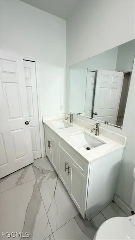 a spacious bathroom with a double vanity sink and a mirror