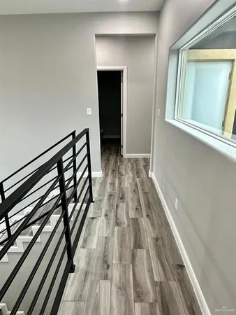 a view of a room with wooden floor and staircase