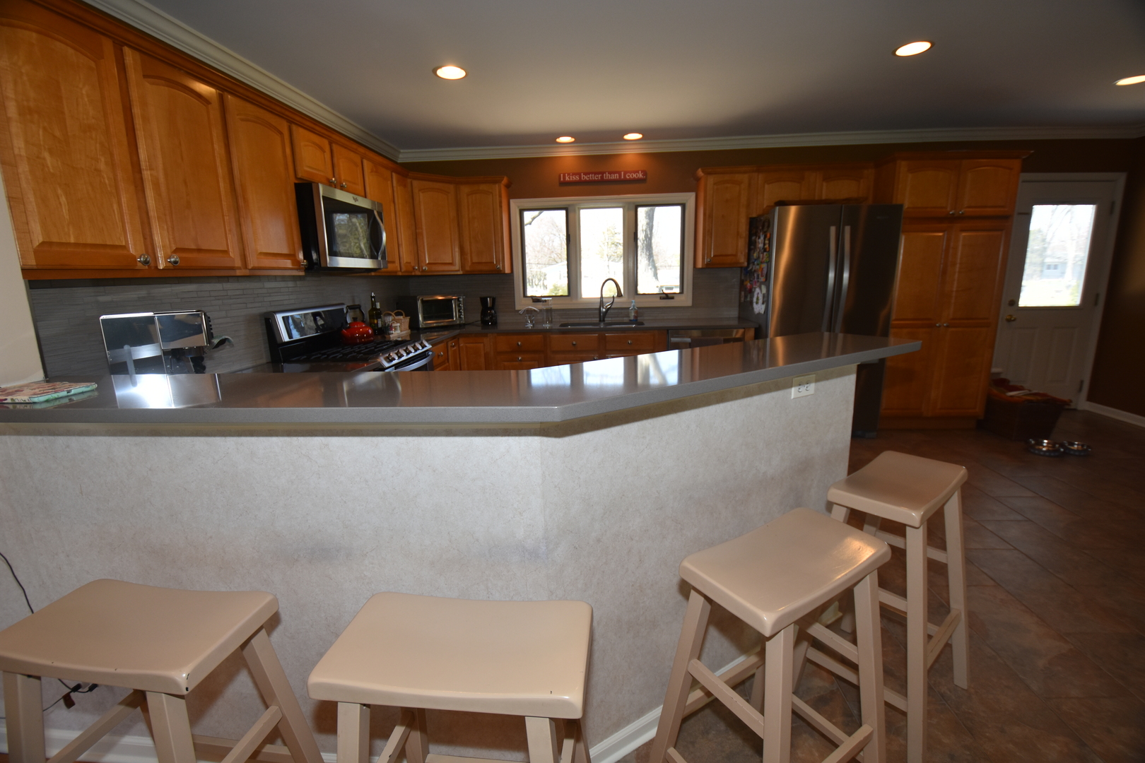 N742 Pleasant Hill Road Wheaton, IL 60187 - Photo 15 of 28 a kitchen with a table chairs refrigerator and microwave