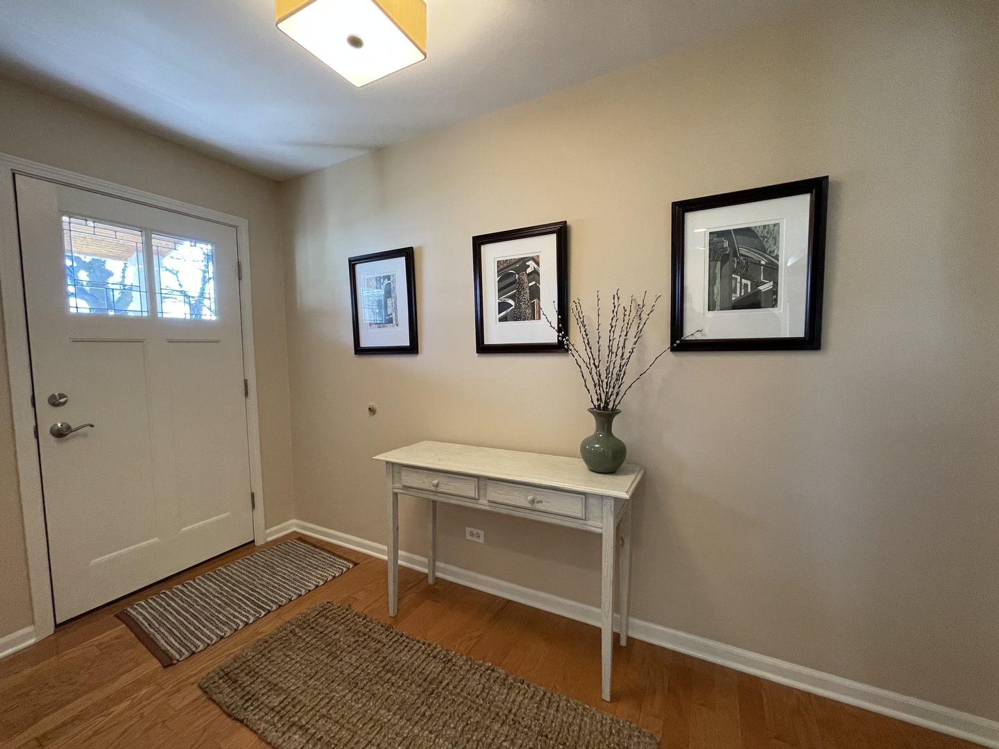 N742 Pleasant Hill Road Wheaton, IL 60187 - Photo 3 of 28 a view of an empty room with wooden floor and a window