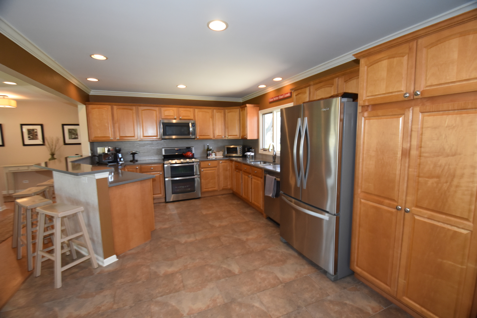 N742 Pleasant Hill Road Wheaton, IL 60187 - Photo 4 of 28 a kitchen with granite countertop stainless steel appliances a refrigerator cabinets and a dining table