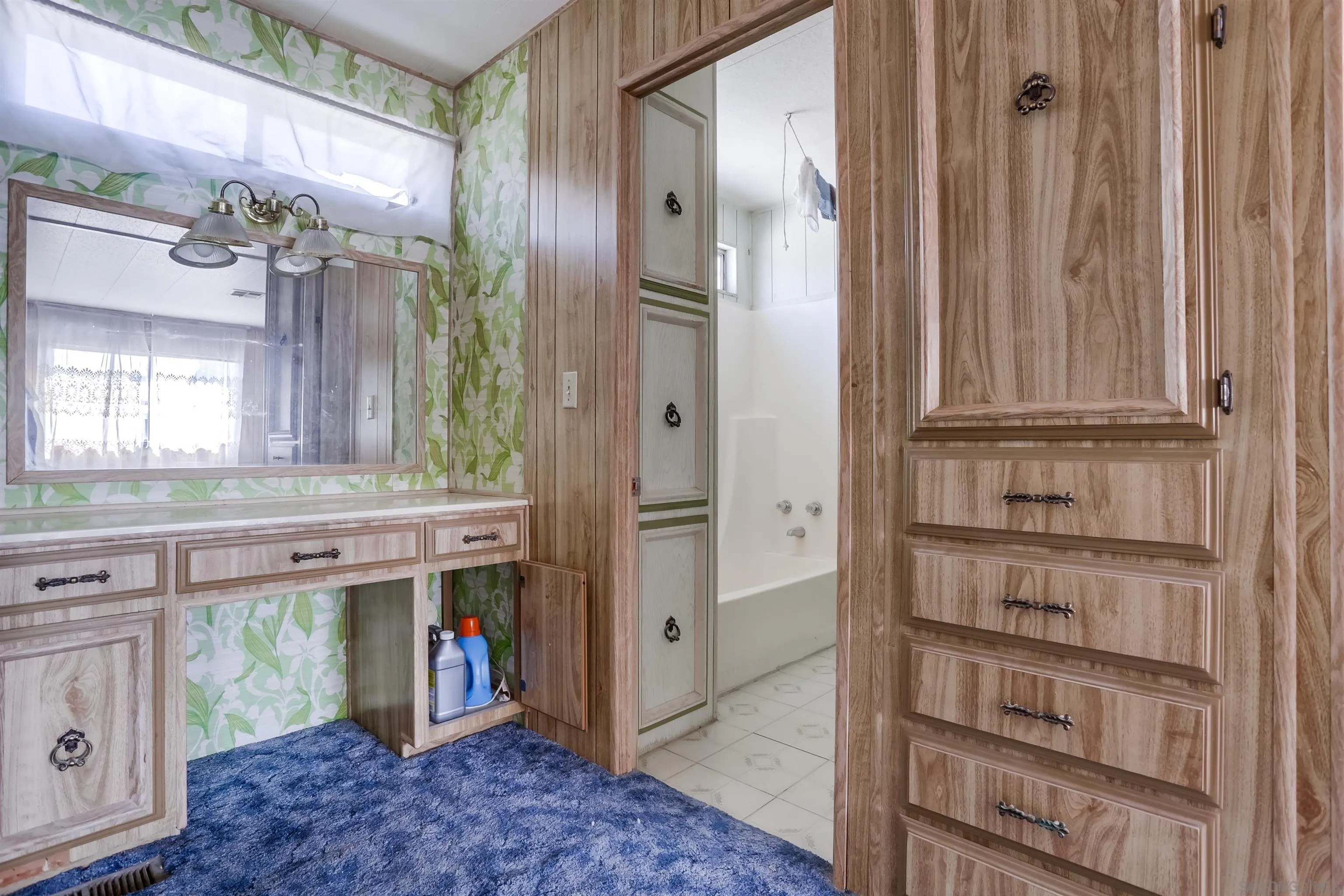 809 Olive Avenue, Unit 11 Vista, CA 92083 - Photo 17 of 26 a view of cabinets and chandelier
