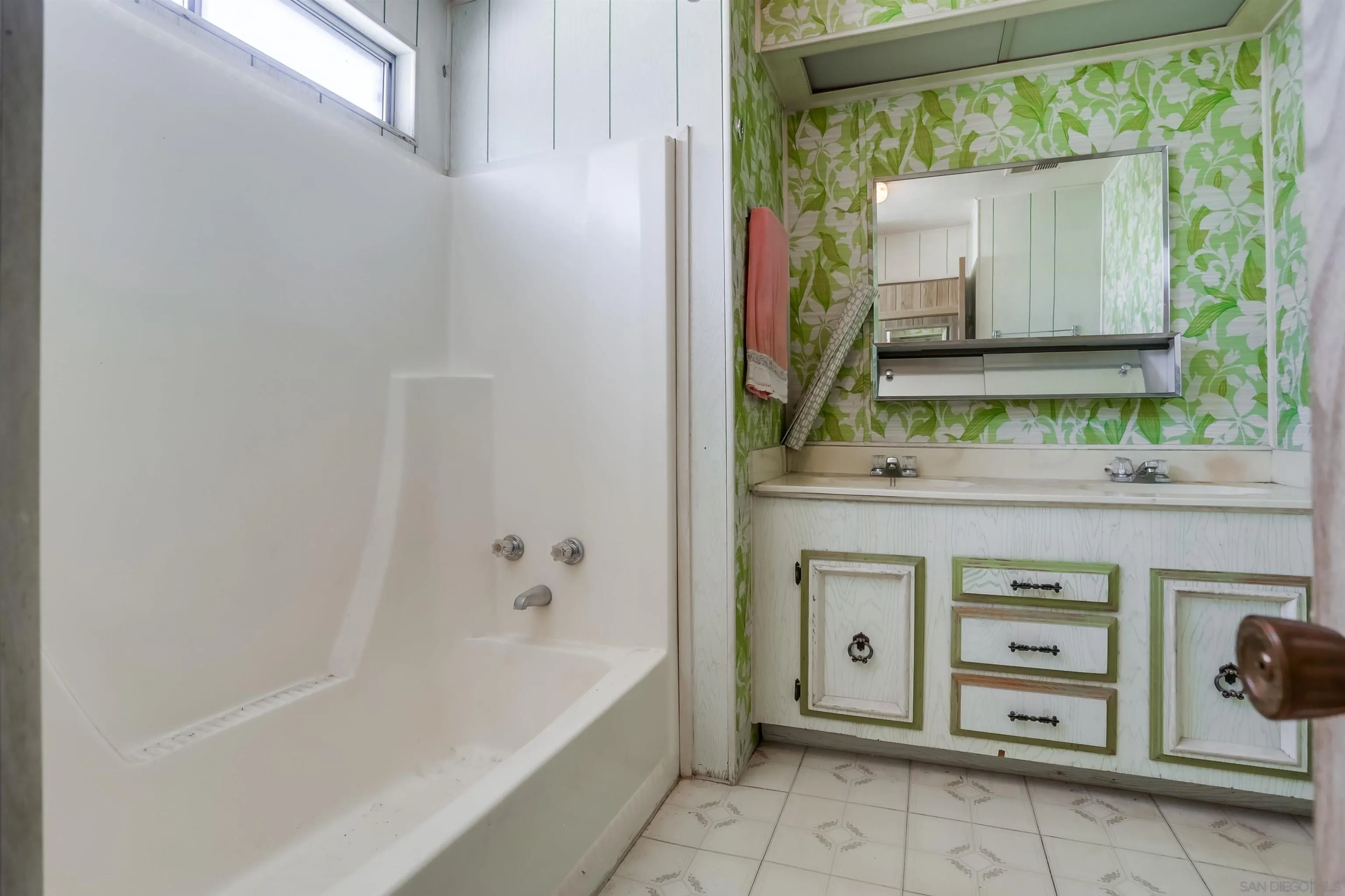809 Olive Avenue, Unit 11 Vista, CA 92083 - Photo 18 of 26 a bathroom with a bathtub sink and mirror