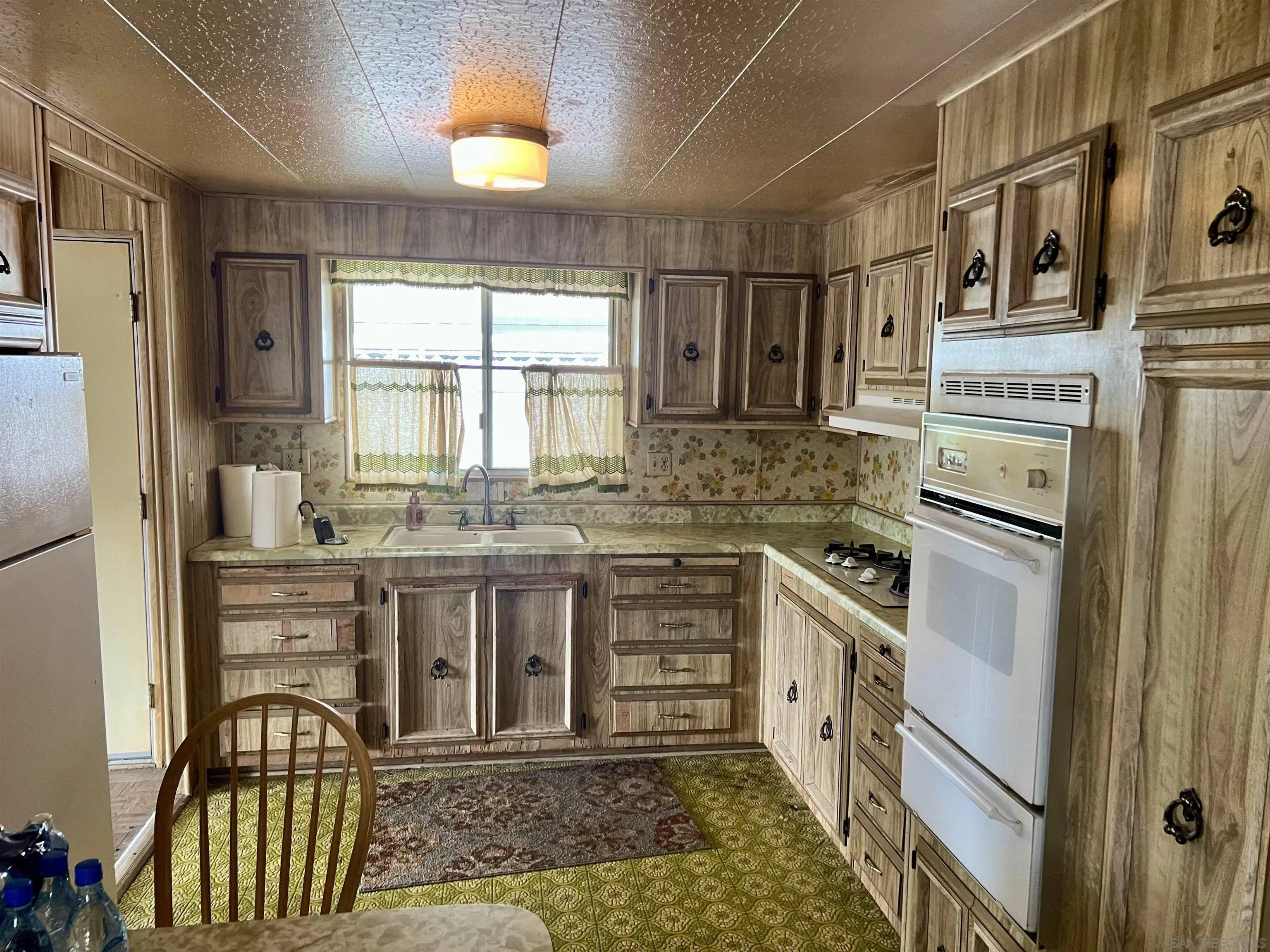 809 Olive Avenue, Unit 11 Vista, CA 92083 - Photo 10 of 26 a kitchen with stainless steel appliances granite countertop a stove a sink and a refrigerator