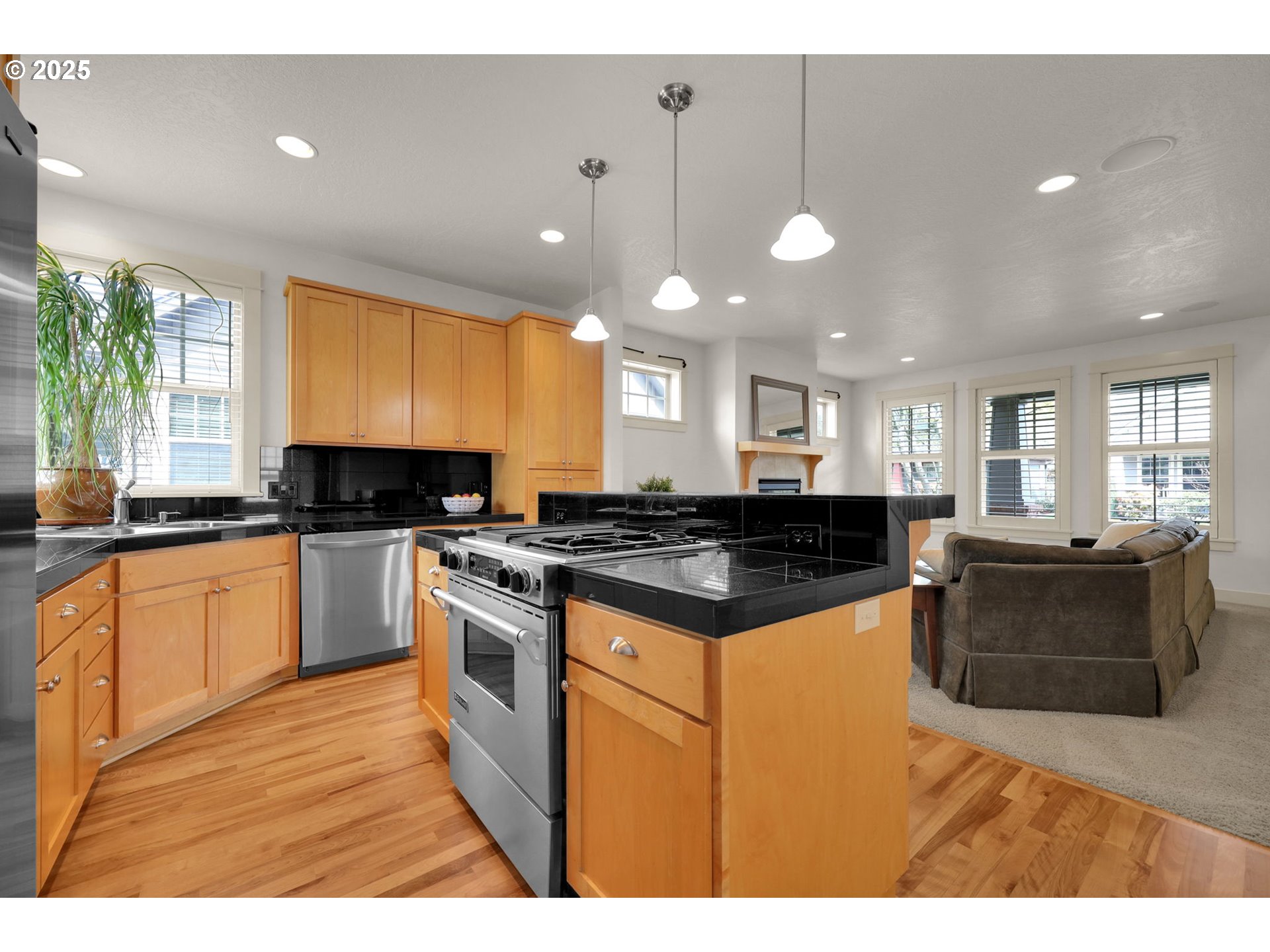 1260 Little John Lane Eugene, OR 97401 - Photo 11 of 44 a kitchen with stainless steel appliances granite countertop a stove a sink a refrigerator and white cabinets