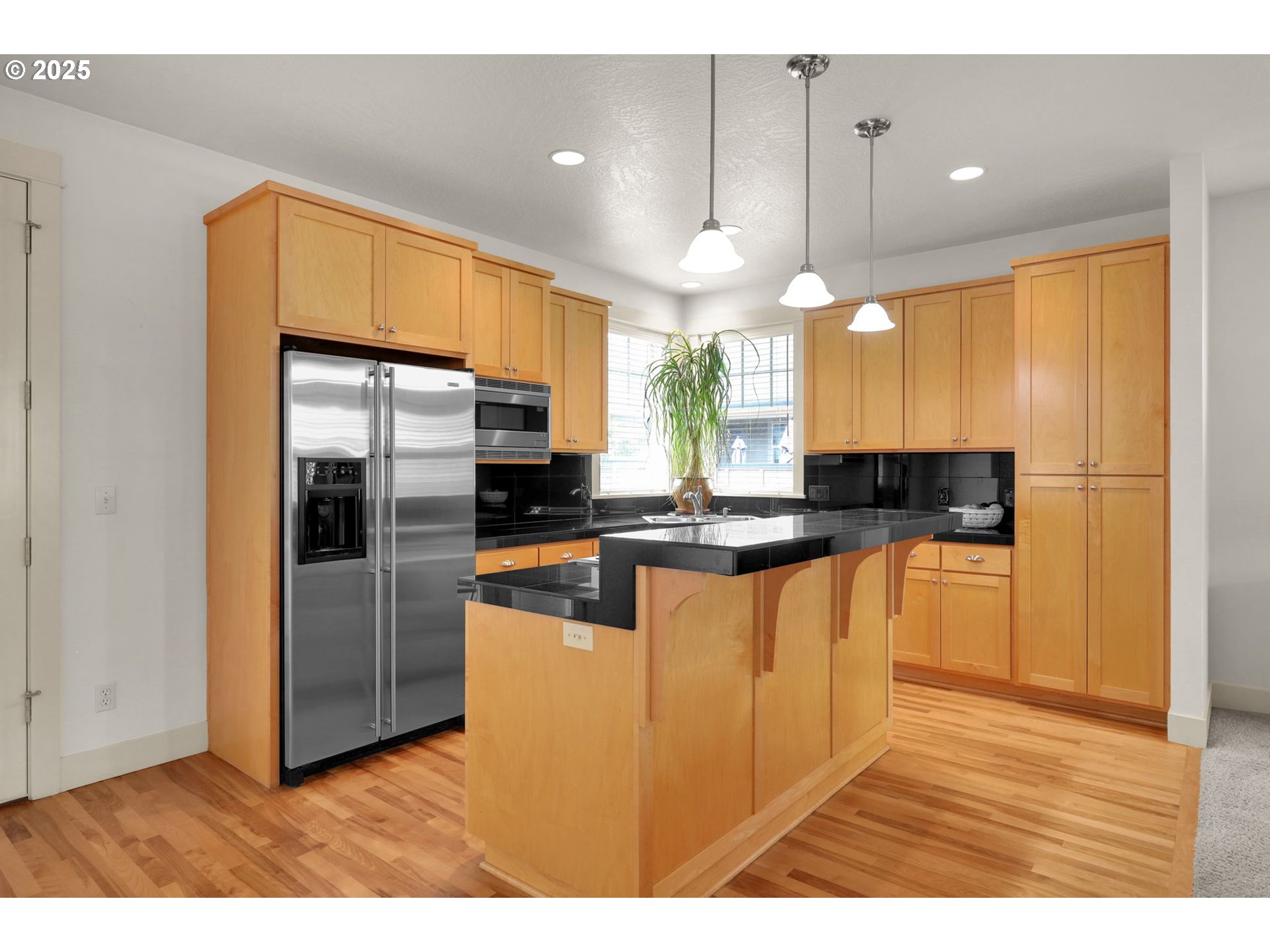 1260 Little John Lane Eugene, OR 97401 - Photo 13 of 44 a kitchen with stainless steel appliances granite countertop a refrigerator a sink a stove and a wooden floors
