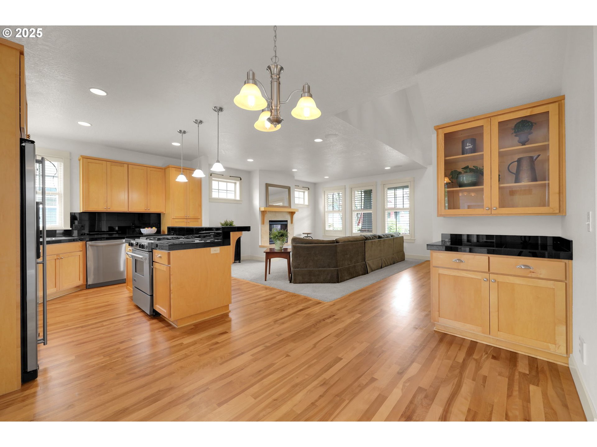 1260 Little John Lane Eugene, OR 97401 - Photo 10 of 44 a large kitchen with stainless steel appliances kitchen island a large counter top and wooden floors