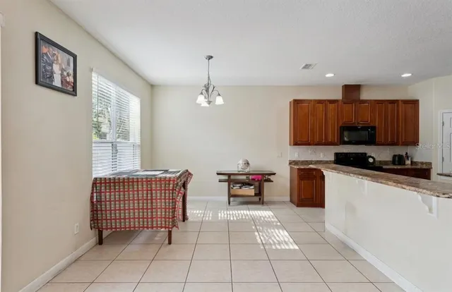 a kitchen with stainless steel appliances granite countertop a refrigerator and a stove top oven