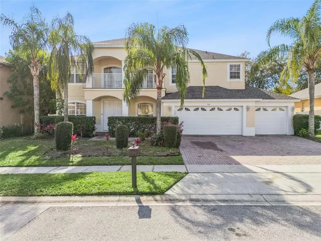 a front view of a house with a garden and plants