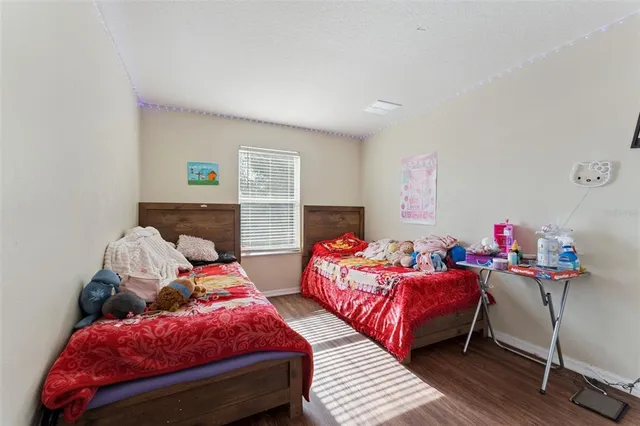 a bedroom with two beds and a couch