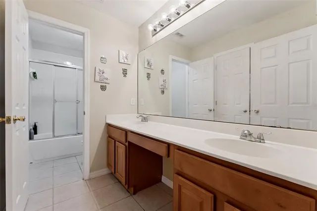 a spacious bathroom with a sink and a mirror