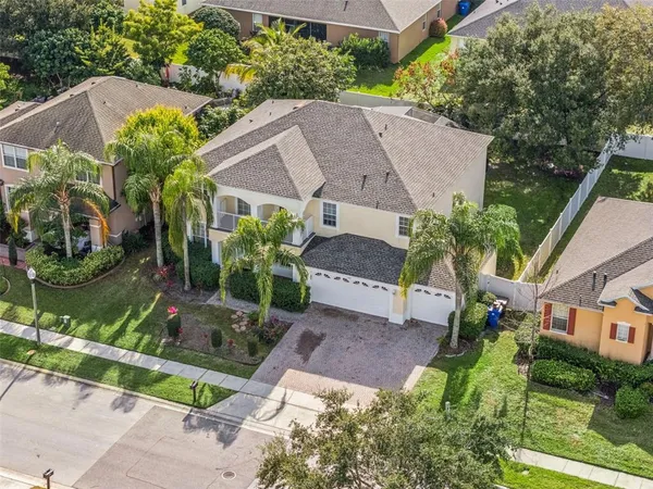an aerial view of a house with garden space and a street view