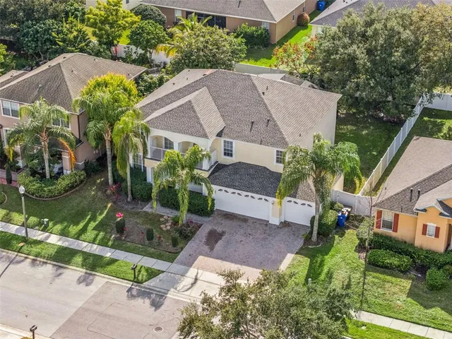 an aerial view of a house with garden space and a street view
