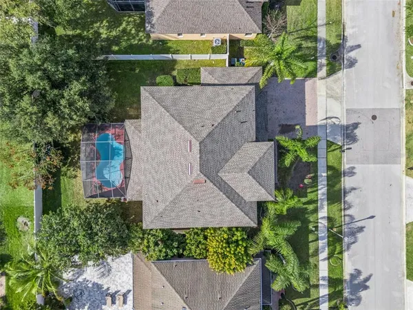 an aerial view of a house with yard