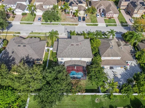 an aerial view of a house with a yard and lake view