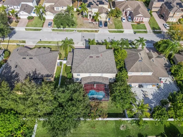 an aerial view of a house with a yard and lake view