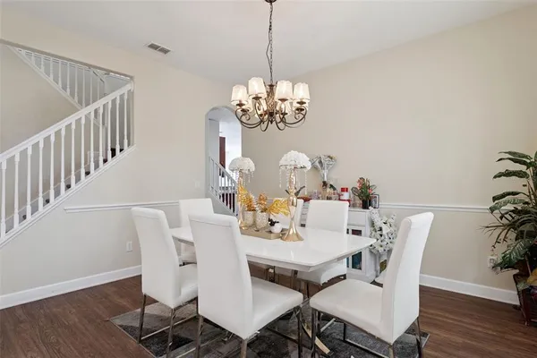 a view of a dining room with furniture wooden floor and chandelier