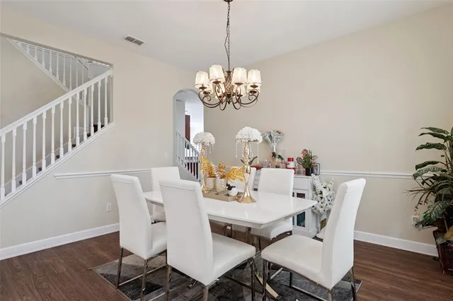 a view of a dining room with furniture wooden floor and chandelier