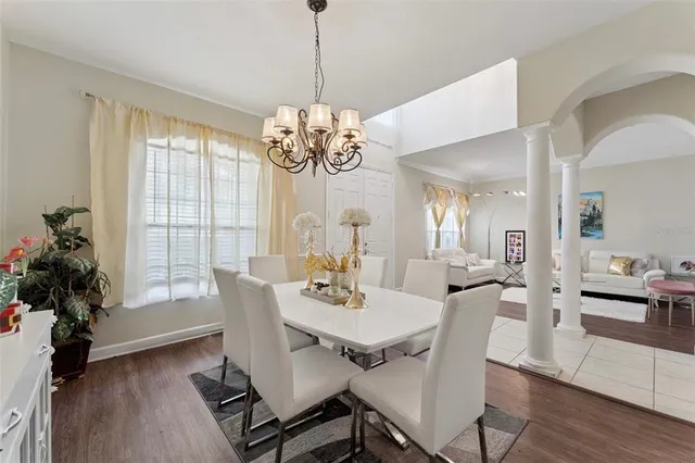 a view of a dining room with furniture wooden floor and chandelier