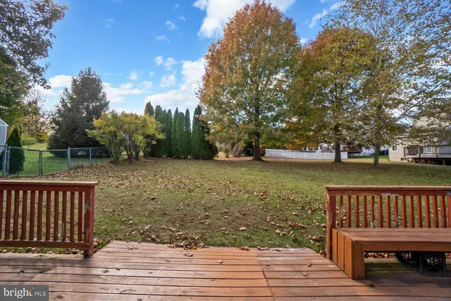 a balcony with wooden floor and lake view