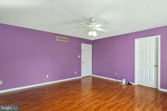 a bathroom with a double vanity sink a large mirror and a bathtub