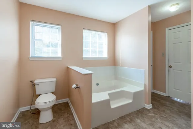 a bath tub sitting next to a window