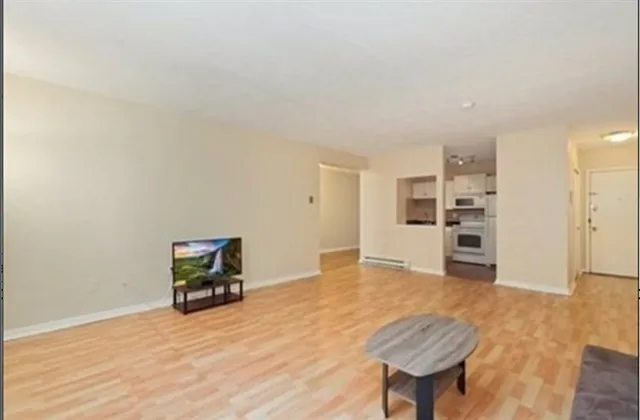 a view of an empty room with a kitchen