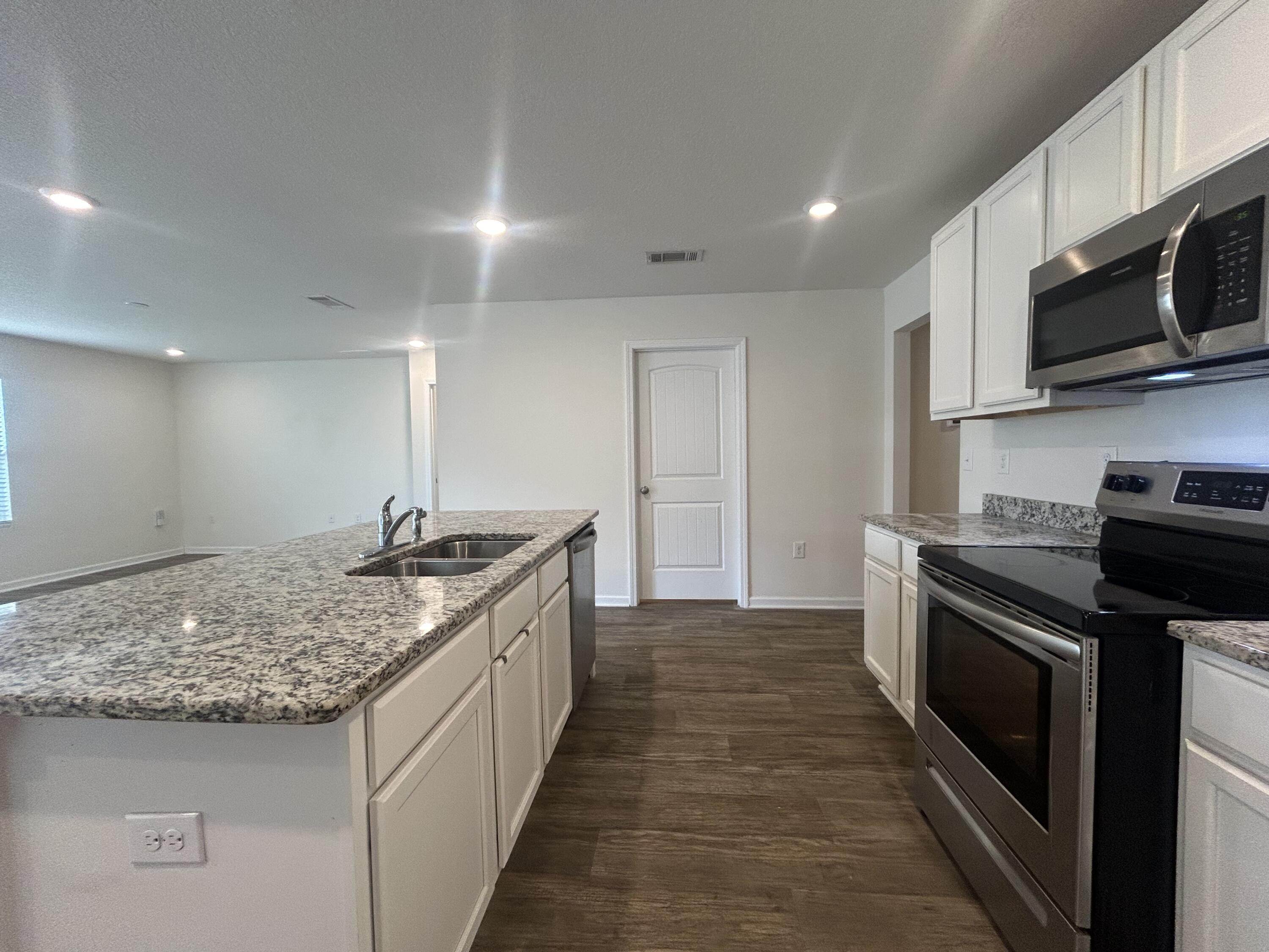 916 Merganser Way Crestview, FL 32539 - Photo 11 of 37 a kitchen with stainless steel appliances granite countertop a sink and stove