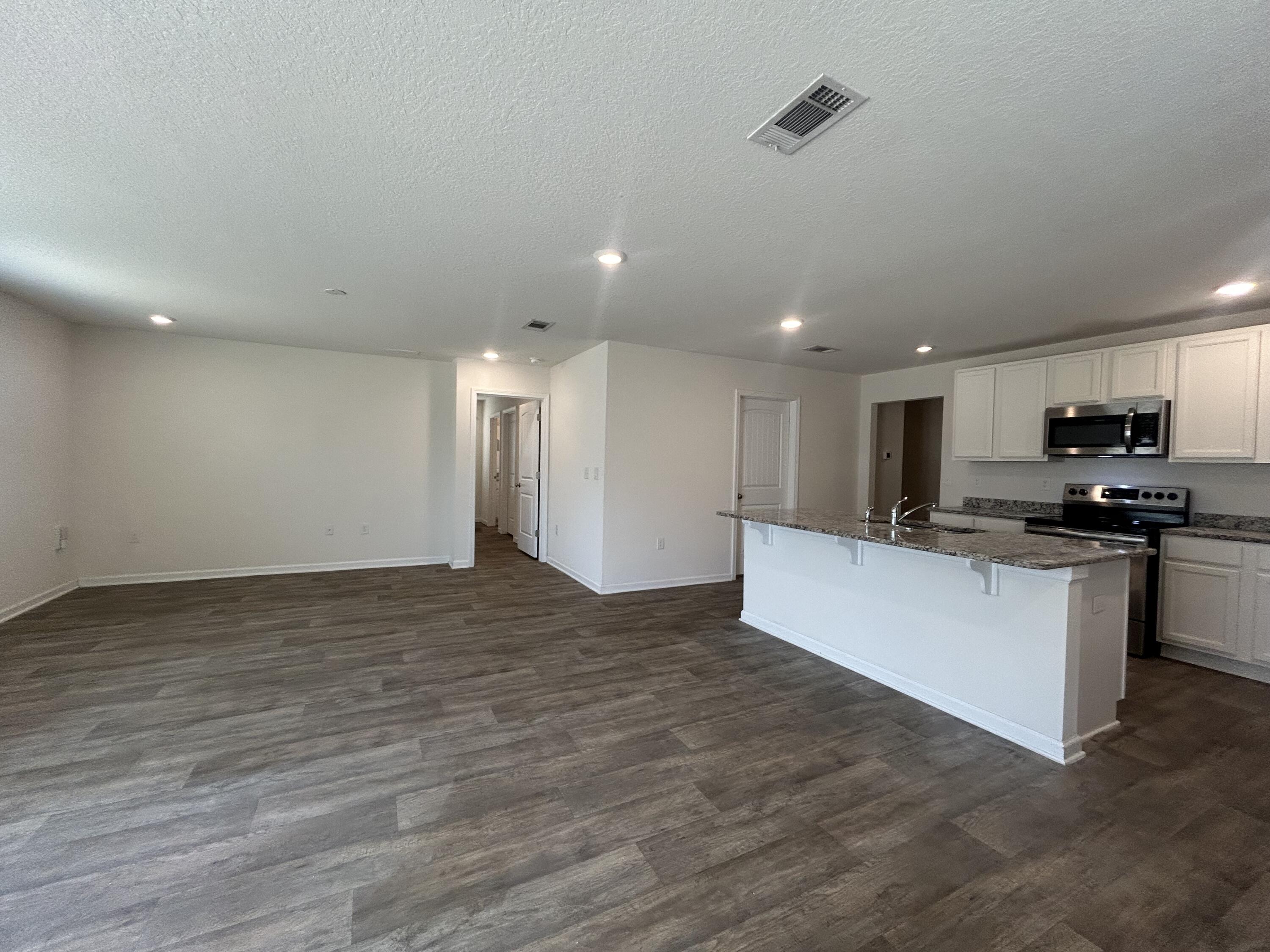 916 Merganser Way Crestview, FL 32539 - Photo 14 of 37 a view of kitchen with kitchen island stainless steel appliances refrigerator stove microwave and cabinets