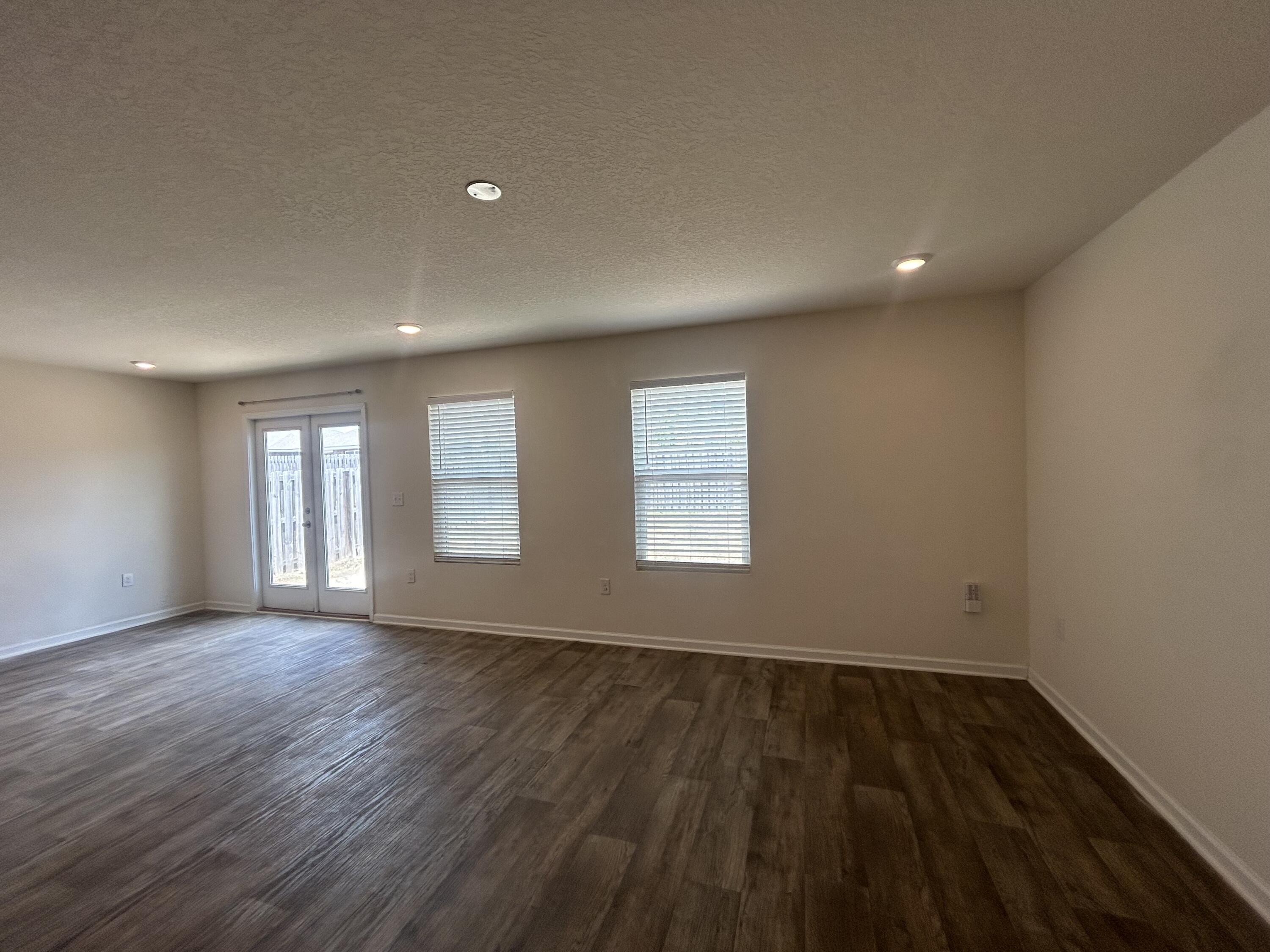 916 Merganser Way Crestview, FL 32539 - Photo 15 of 37 an empty room with wooden floor and windows