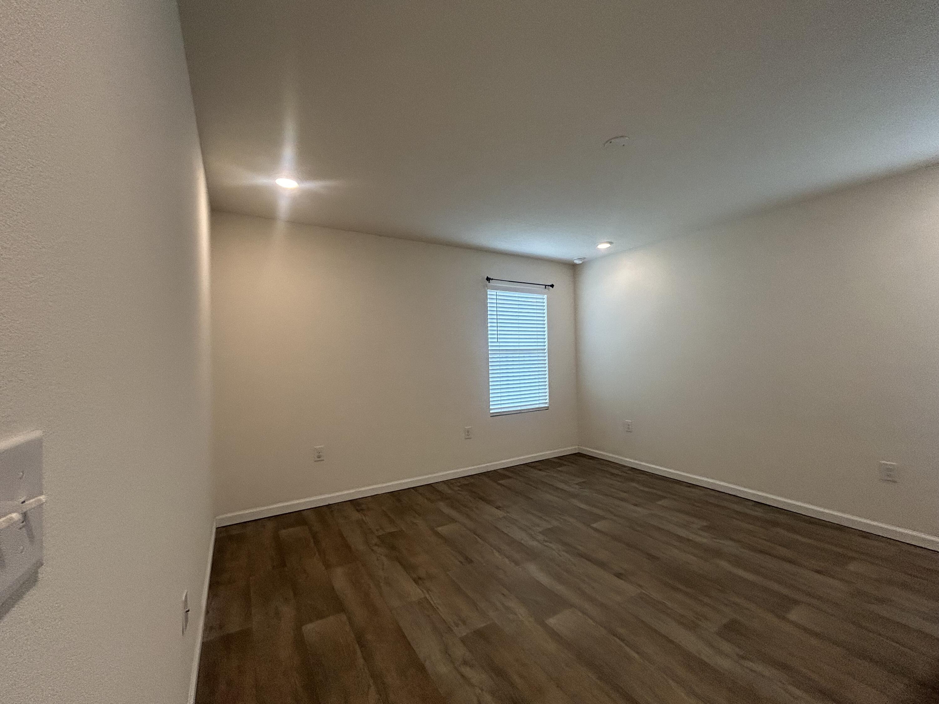 916 Merganser Way Crestview, FL 32539 - Photo 31 of 37 an empty room with wooden floor and windows