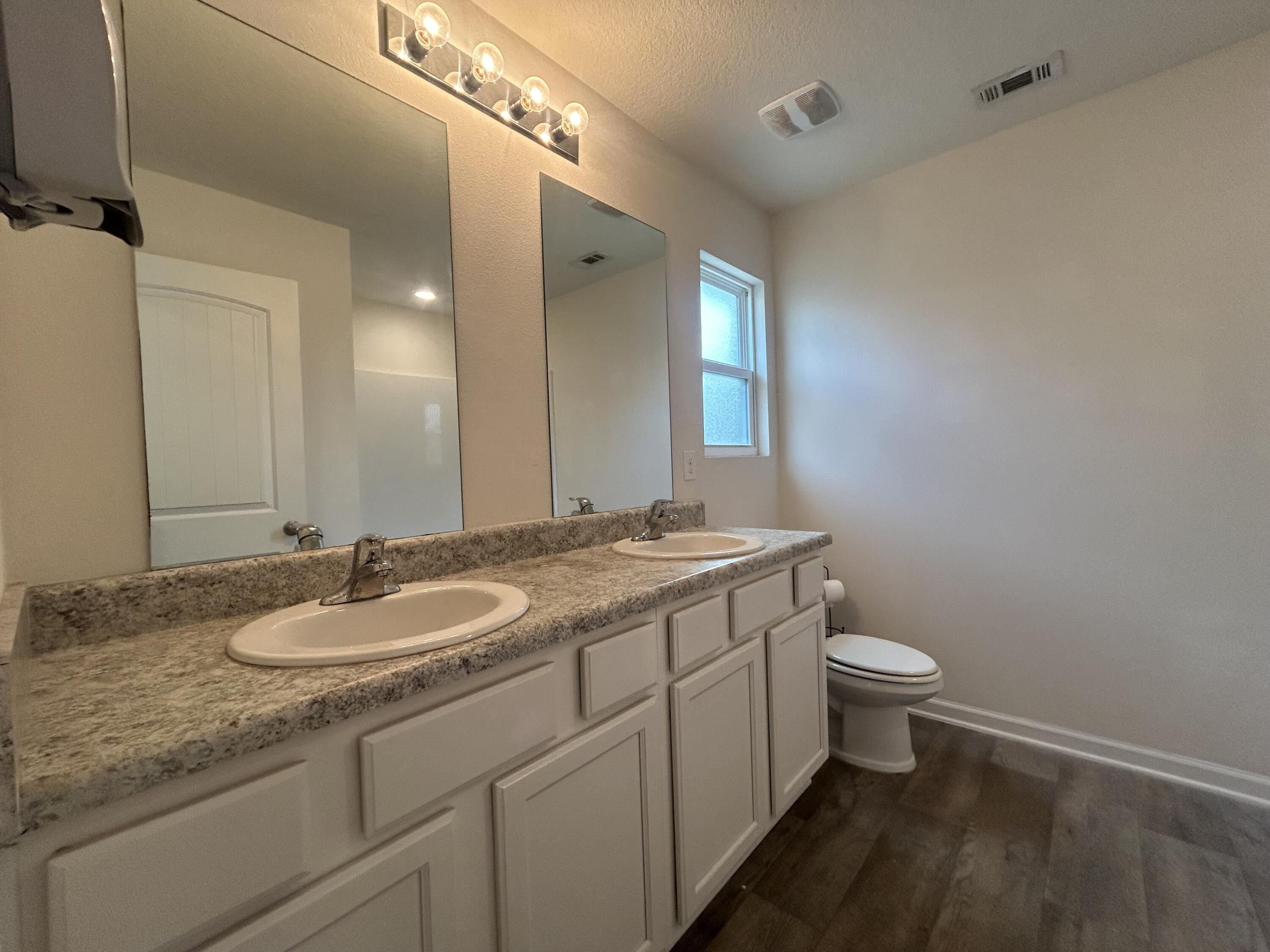 916 Merganser Way Crestview, FL 32539 - Photo 34 of 37 a bathroom with a granite countertop sink toilet and mirror