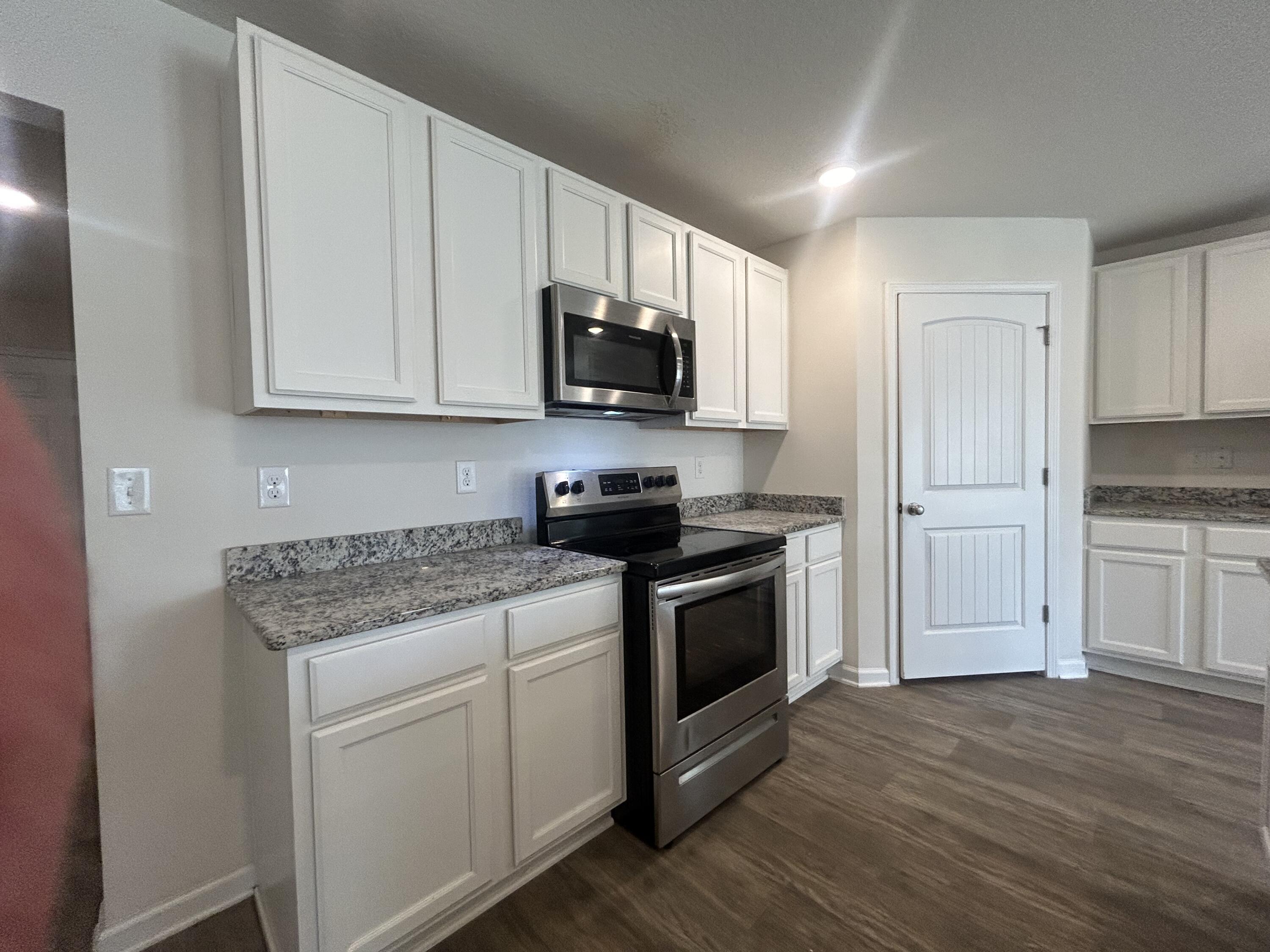 916 Merganser Way Crestview, FL 32539 - Photo 6 of 37 a kitchen with stainless steel appliances granite countertop a stove and a refrigerator