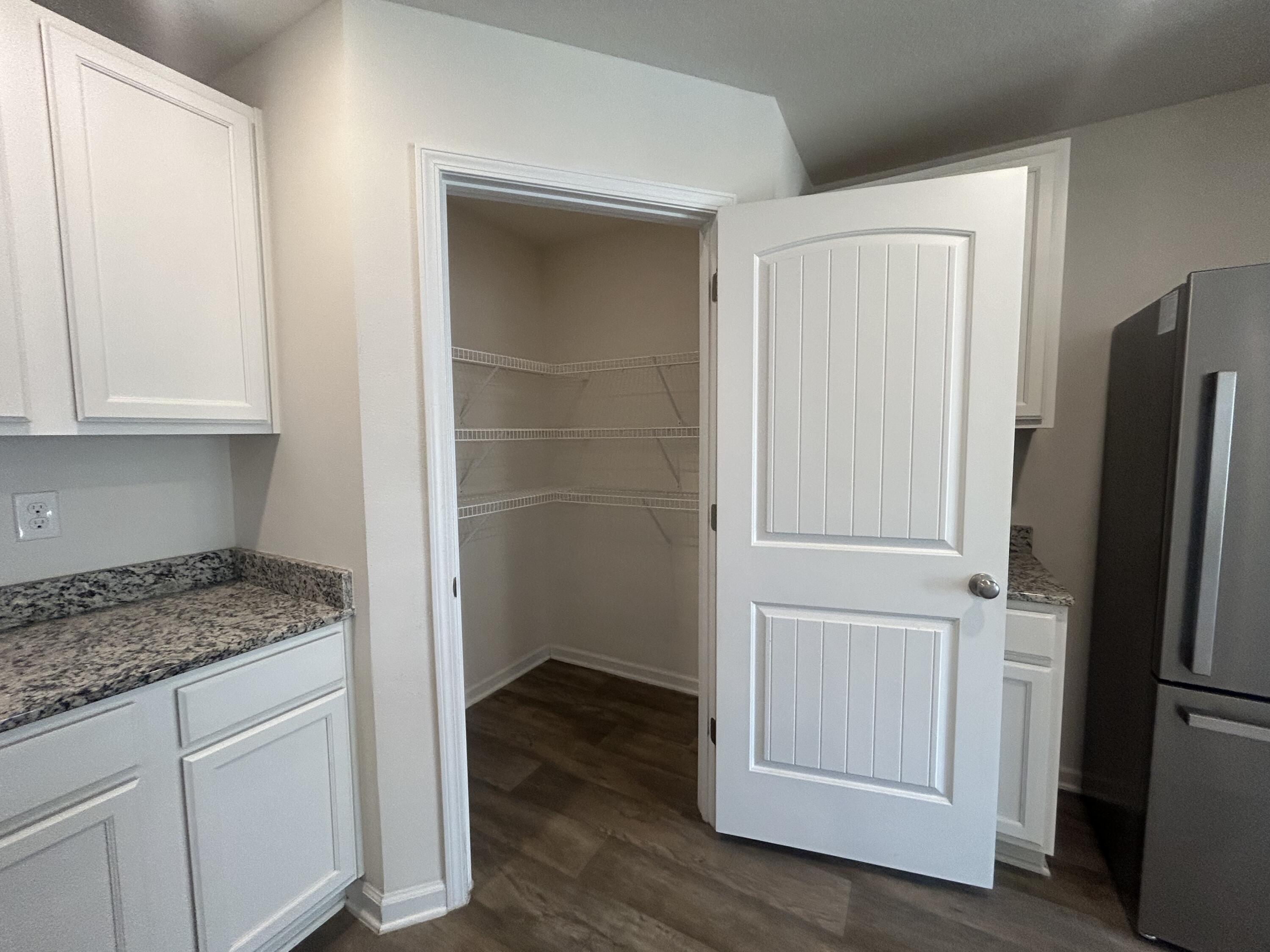 916 Merganser Way Crestview, FL 32539 - Photo 9 of 37 a kitchen with a refrigerator and cabinets