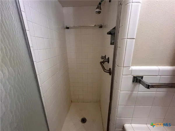 a bathroom with a glass shower door
