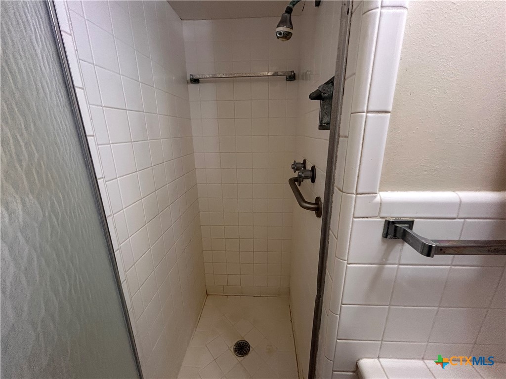 614 Apollo Drive Edna, TX 77957 - Photo 15 of 41 a bathroom with a glass shower door