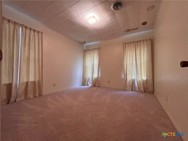 a bathroom with a toilet and a shower curtain