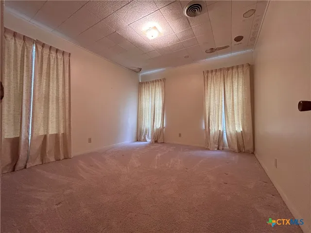 a bathroom with a toilet and a shower curtain