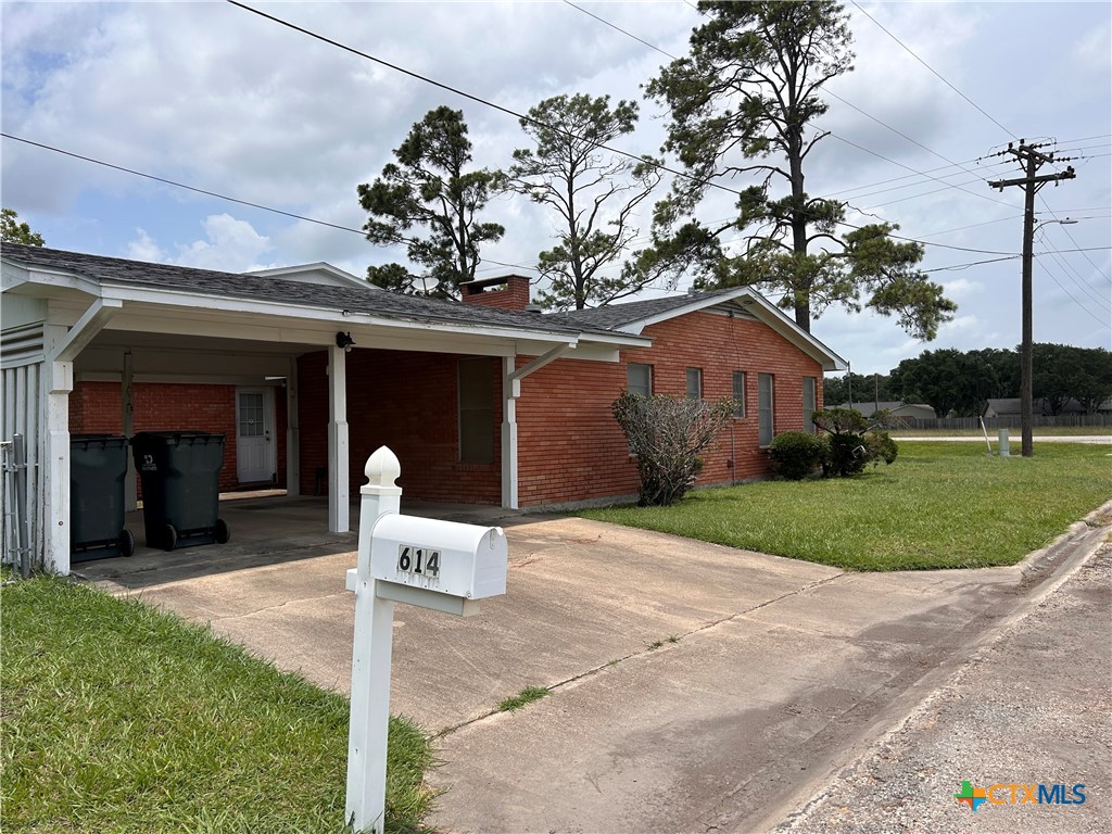 614 Apollo Drive Edna, TX 77957 - Photo 25 of 41 a front view of a house with a yard and garage