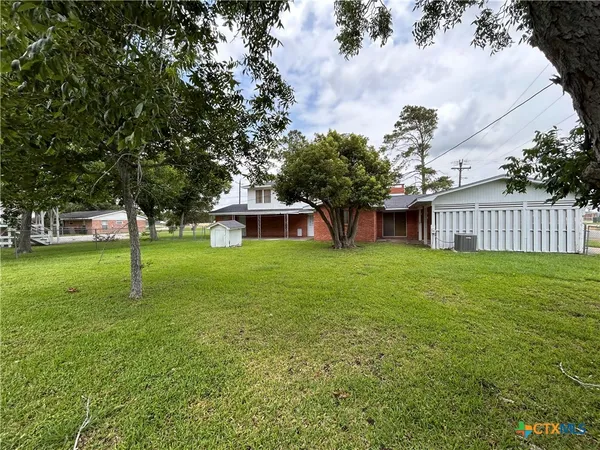 a view of a backyard with large trees