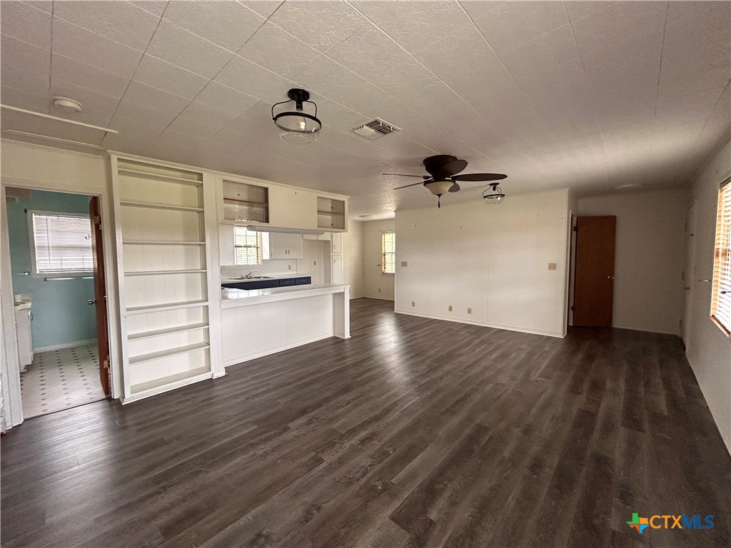 614 Apollo Drive Edna, TX 77957 - Photo 33 of 41 an empty room with wooden floor cabinet and windows