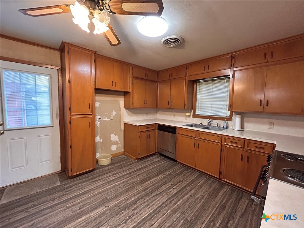 614 Apollo Drive Edna, TX 77957 - Photo 7 of 41 a kitchen with stainless steel appliances granite countertop a sink a stove a refrigerator and island with wooden floor