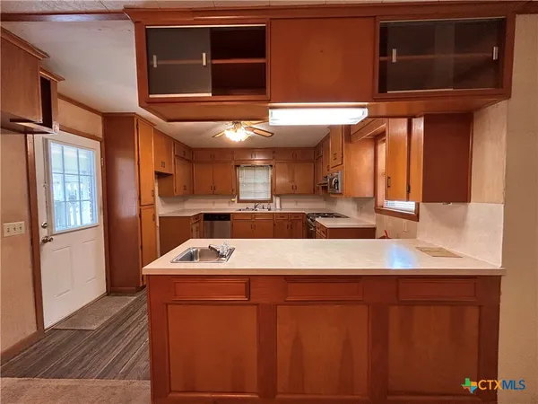 a kitchen with stainless steel appliances granite countertop a sink and a microwave